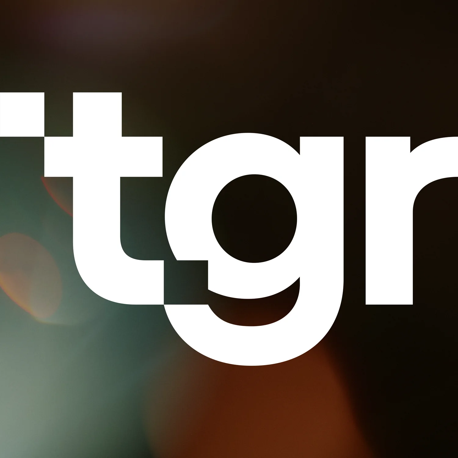 The lowercase tgr wordmark in white on a dark background.