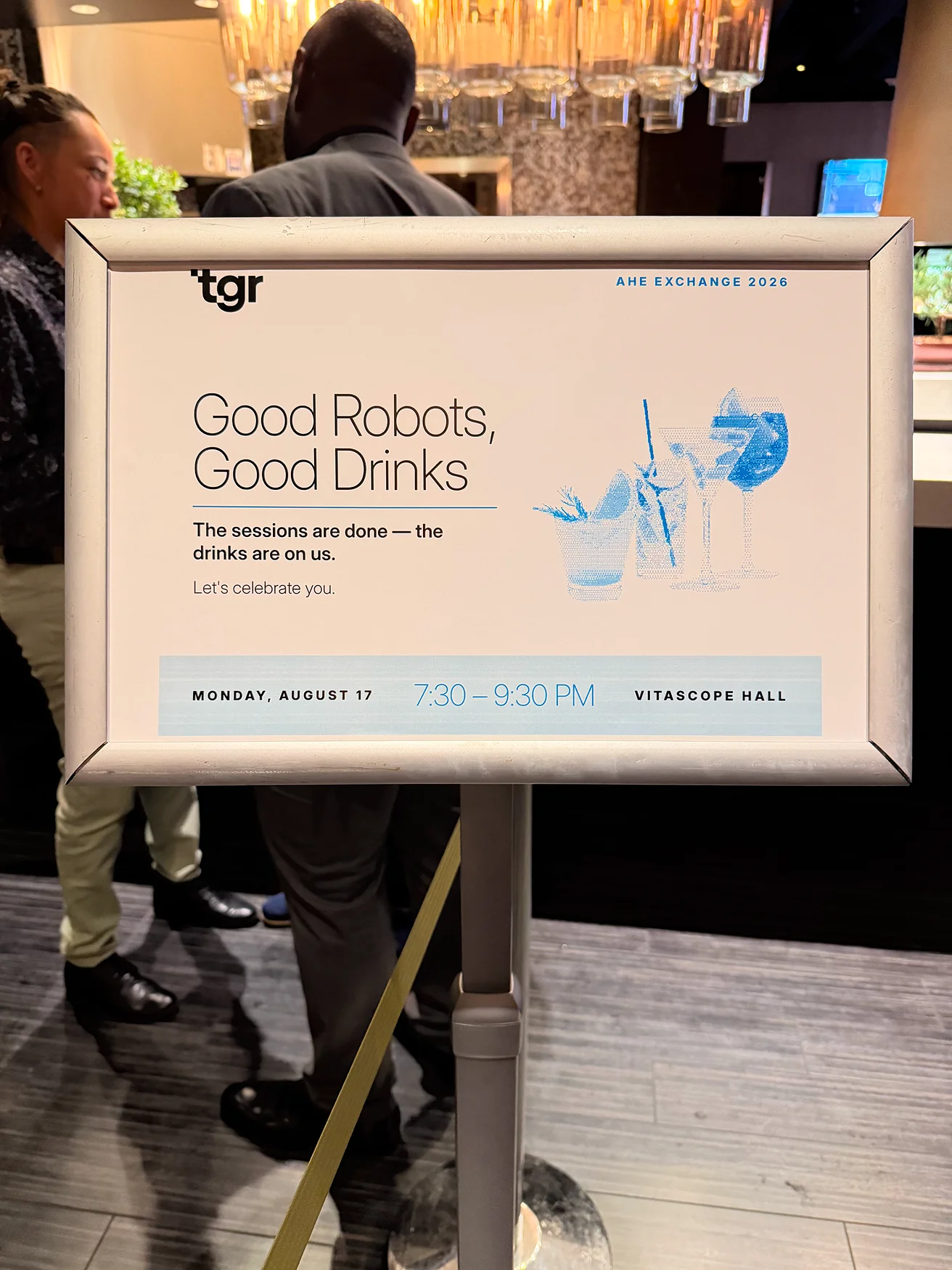 一块装裱的 TGR 前台标牌，上面写着 Good Robots, Good Drinks。