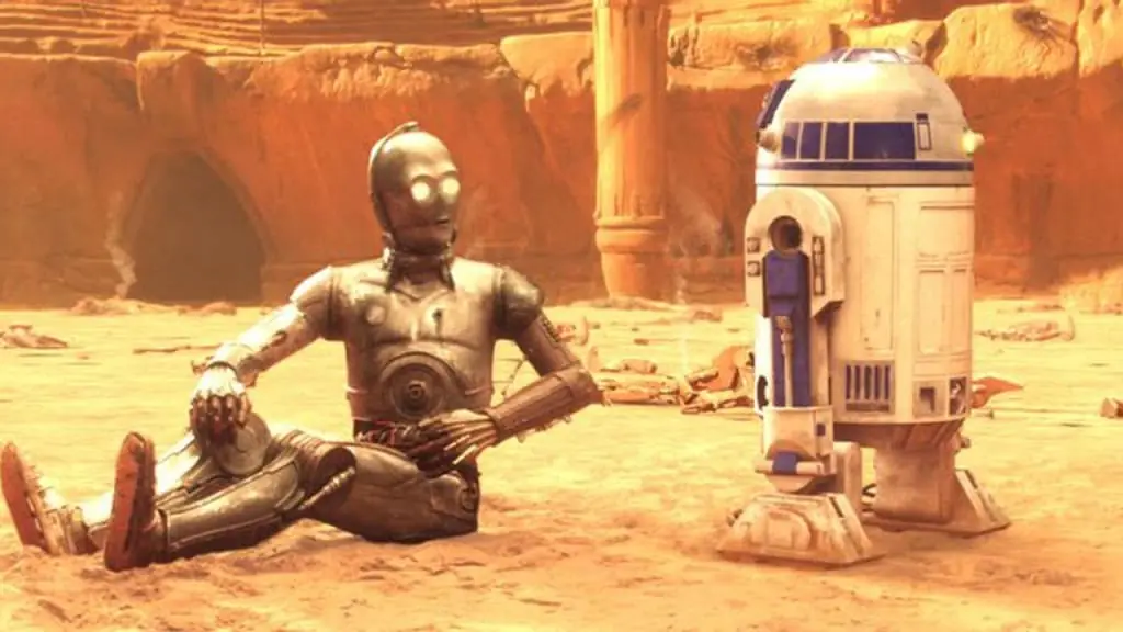 C-3PO and R2-D2 together in a desert scene, illustrating robot sidekicks in Star Wars.