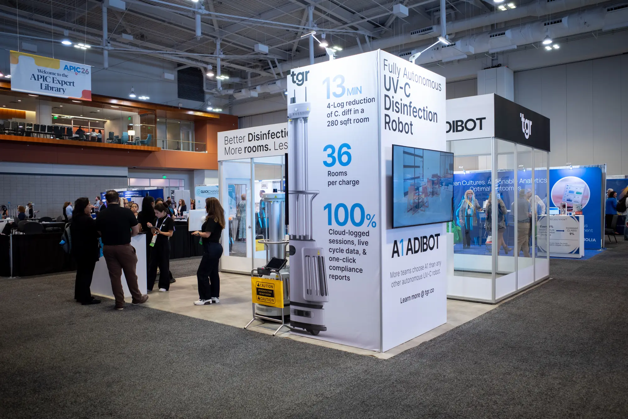 TGR exhibition booth at APIC26 with A1 robots and tall product displays.